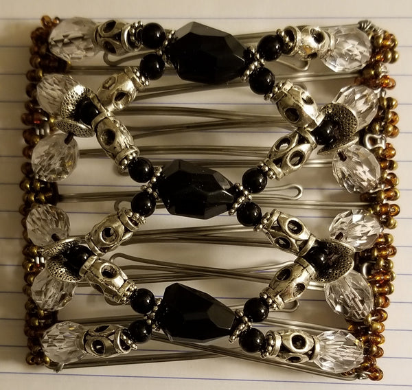 9 tooth - very nice, elegant,  metal silver tube beads with black faceted center beads and clear faceted beads. Elegant.