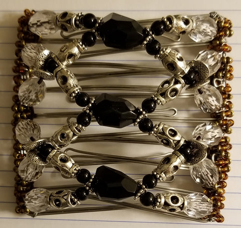 9 tooth - very nice, elegant,  metal silver tube beads with black faceted center beads and clear faceted beads. Elegant.
