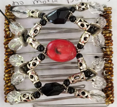 9 tooth  great for medium to thick hair. Black and silver. Real coral center!